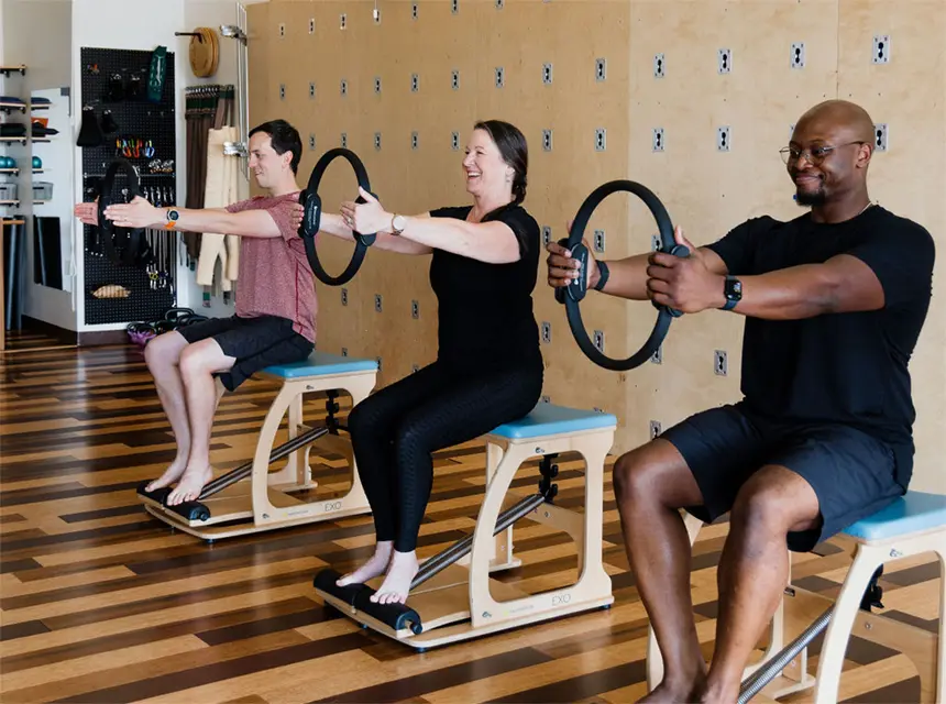 pilates-group-class Several studentsare using a Magic Circle during a small group Pilates Chair class in Huntsville Al